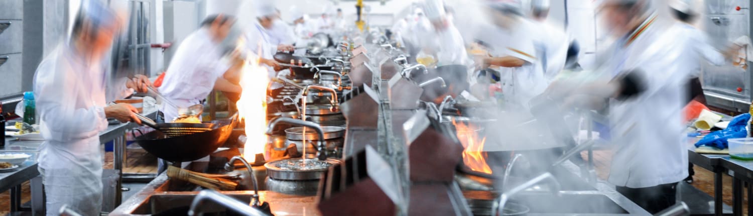 Motion chefs working in Chinese restaurant kitchen